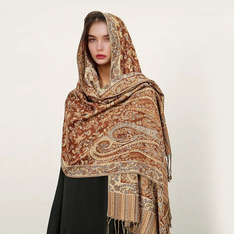 Chocolate brown Tibetan paisley shawl with jacquard weaving worn as cozy sofa throw blanket