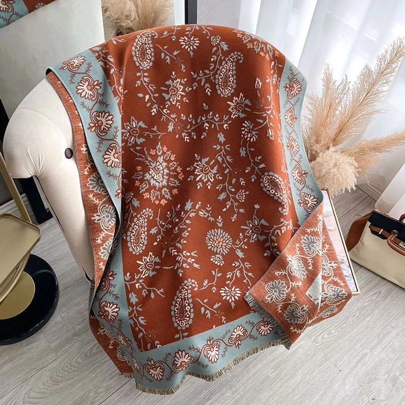 Tibetan handwoven paisley shawl flat lay view with rust brown woven fabric and blue paisley border