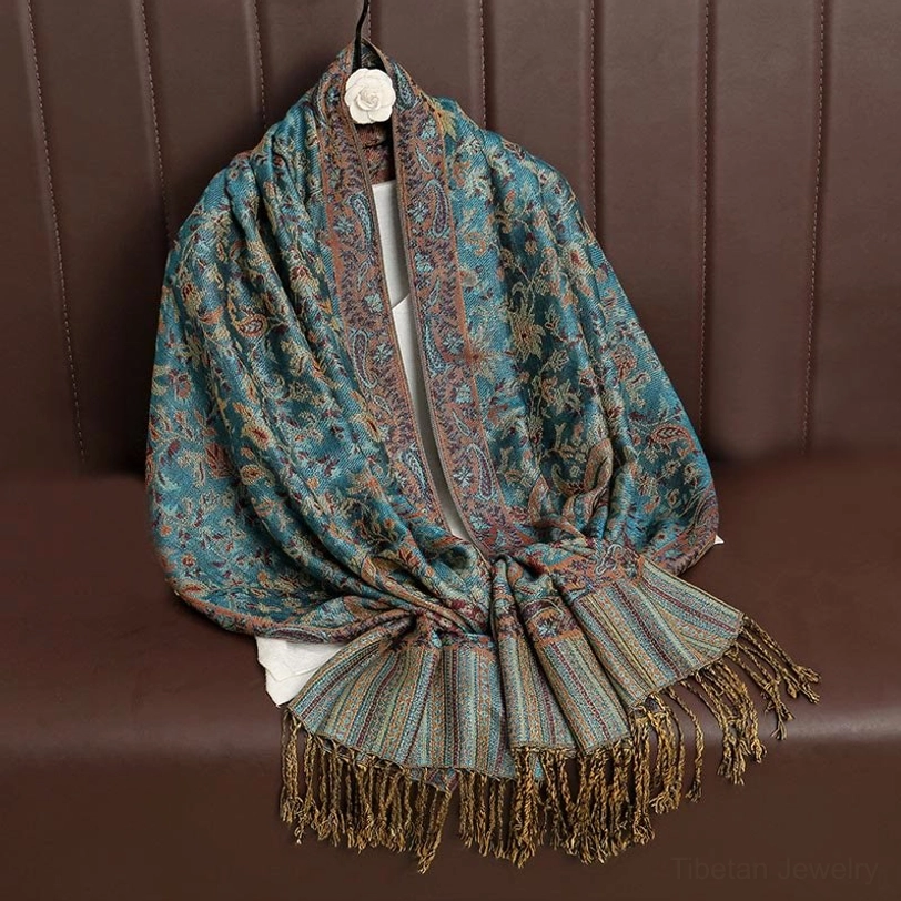 Tibetan paisley shawl layered styling showing versatility with coats and sweaters for contemporary fashion
