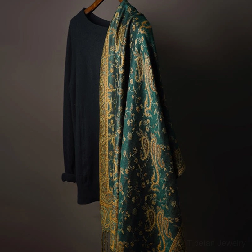 Tibetan paisley shawl draped on hanger showing the full length and flowing design of the vintage floral print