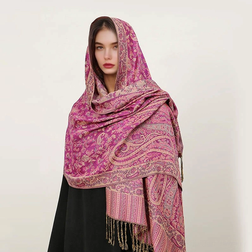 Tibetan handcrafted paisley shawl worn as travel blanket showing comfort and versatility