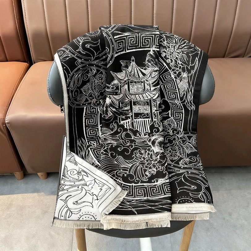 Tibetan pavilion scarf draped on chair back three-quarter view displaying geometric floral border patterns and tassel hem details