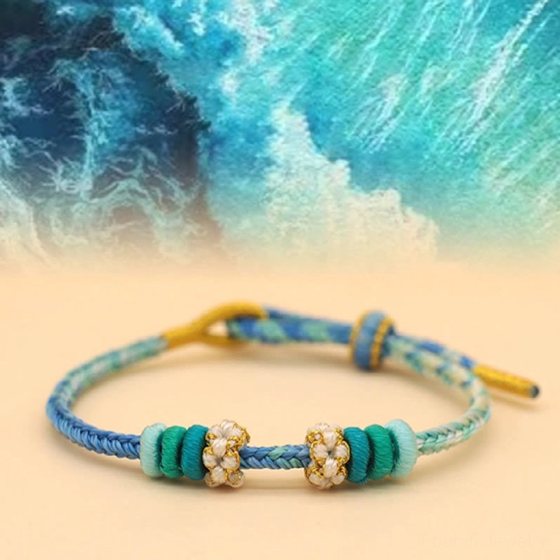 Blue sea green handwoven Tibetan eight-thread peace knot bracelet with traditional Buddhist design elements