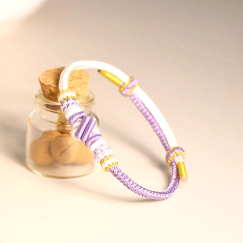 Handcrafted Tibetan peace knot bracelet collection showcasing multiple color variations and sacred eight-thread designs