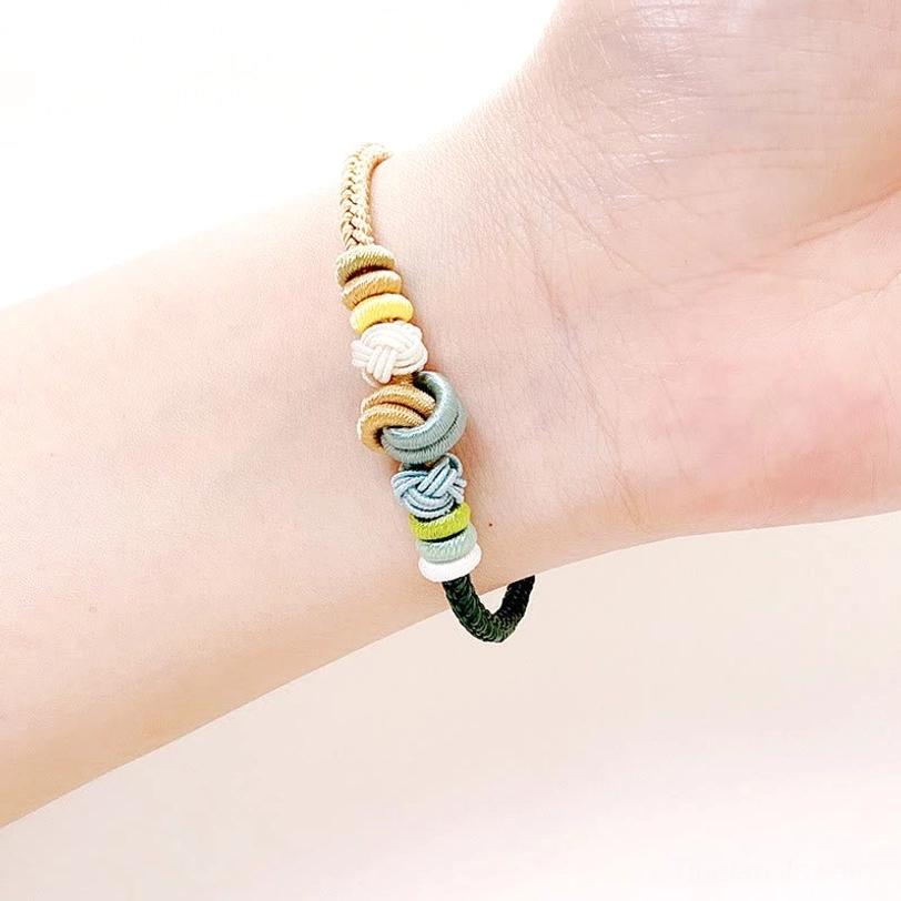 Tibetan eight-thread peace knot bracelet white and purple colorway, handwoven spiritual protection cord
