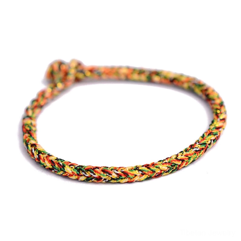 Tibetan eight-thread peace knot blessing bracelet worn on wrist showing comfortable fit and authentic braid pattern