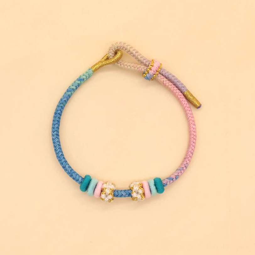 Tri-color pastel woven peace knot bracelet in blue, pink and purple with floral bead ornaments