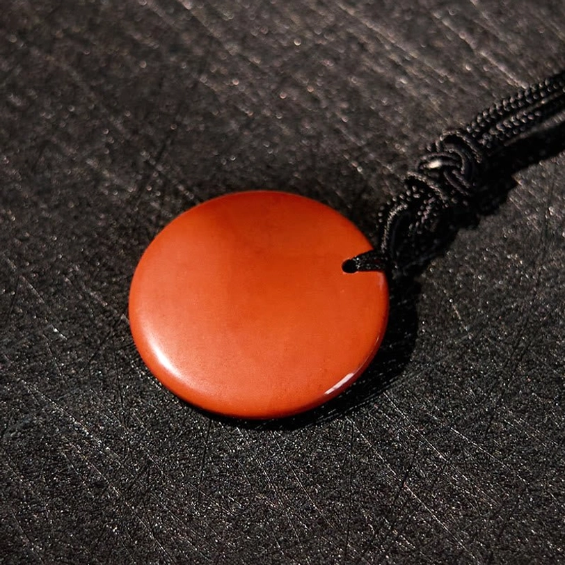 Buddhist pendant necklace showing rope cord detail and pendant attachment