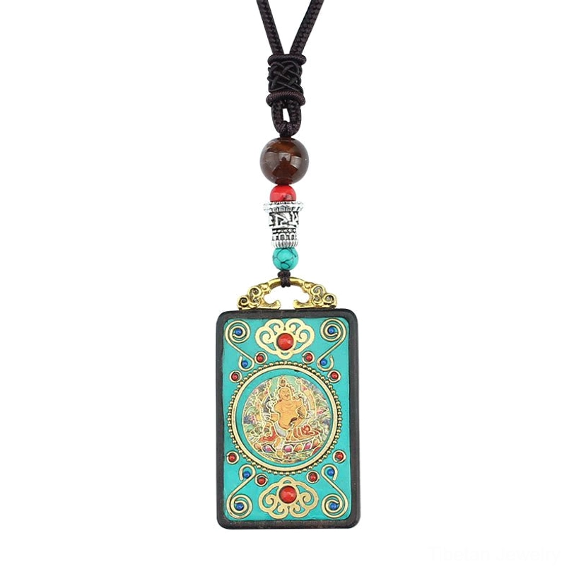 Tibetan thangka pendant necklace with compact Buddha design, braided black rope with decorative beads hanging vertically on light background
