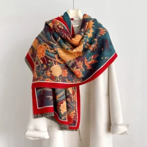 Tibetan phoenix peony scarf worn on shoulders with mannequin, showing red border trim and soft woven texture with tassel hem
