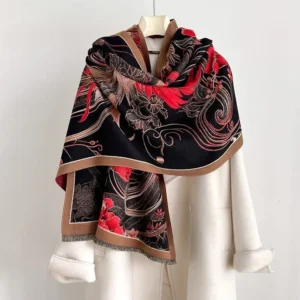 Tibetan phoenix flower tassel shawl worn as elegant black and red thermal wrap over white coat, showing frontal styling and cultural pattern details