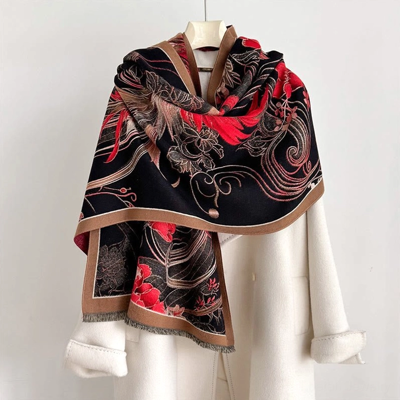 Tibetan phoenix flower tassel shawl worn as elegant black and red thermal wrap over white coat, showing frontal styling and cultural pattern details
