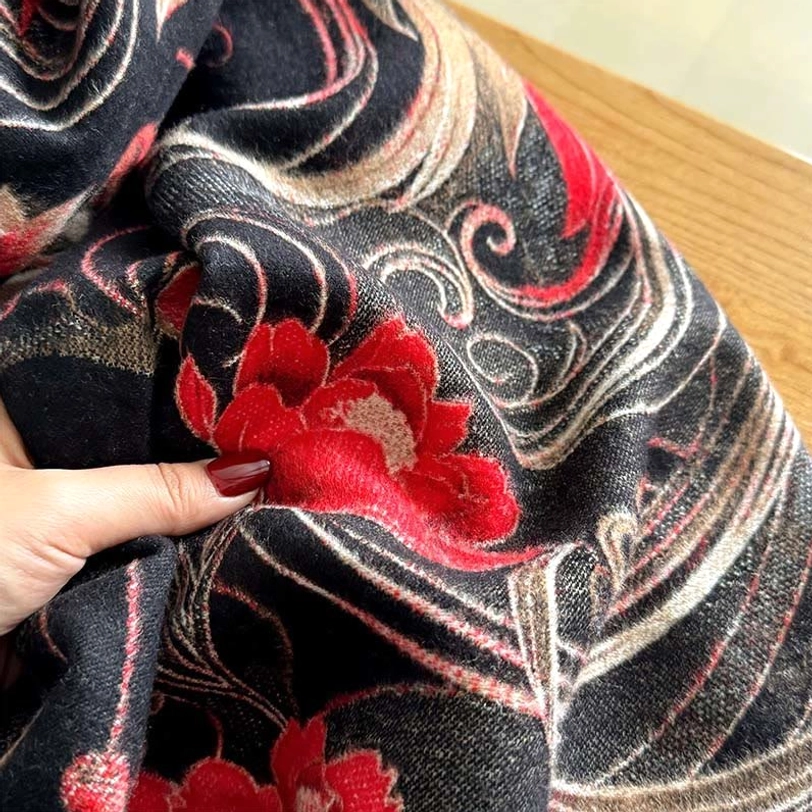 Close-up overhead view of Tibetan phoenix flower tassel shawl, highlighting embossed floral-phoenix intricate patterns and thick plush thermal-weight fabric weave