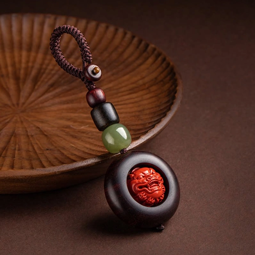 Tibetan Pi Xiu prosperity keychain with hand-carved celestial guardian figure and red sandalwood