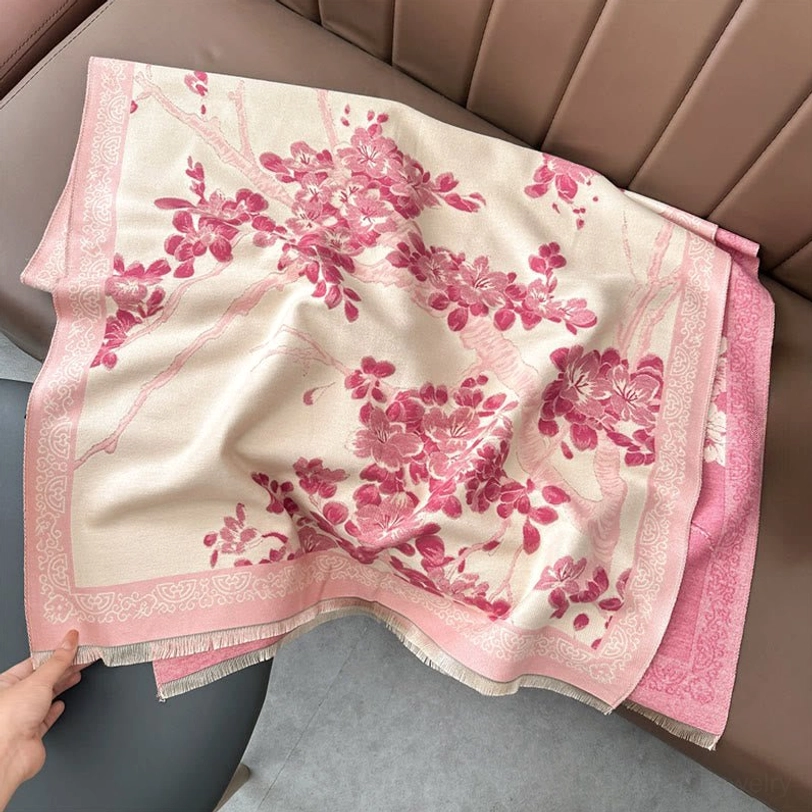 Light pink Tibetan plum blossom scarf flat lay on brown leather sofa with beige base and light pink floral print