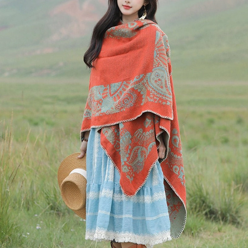 Oversized Tibetan poncho with asymmetric hem and decorative edge trim, right front view outdoor scene