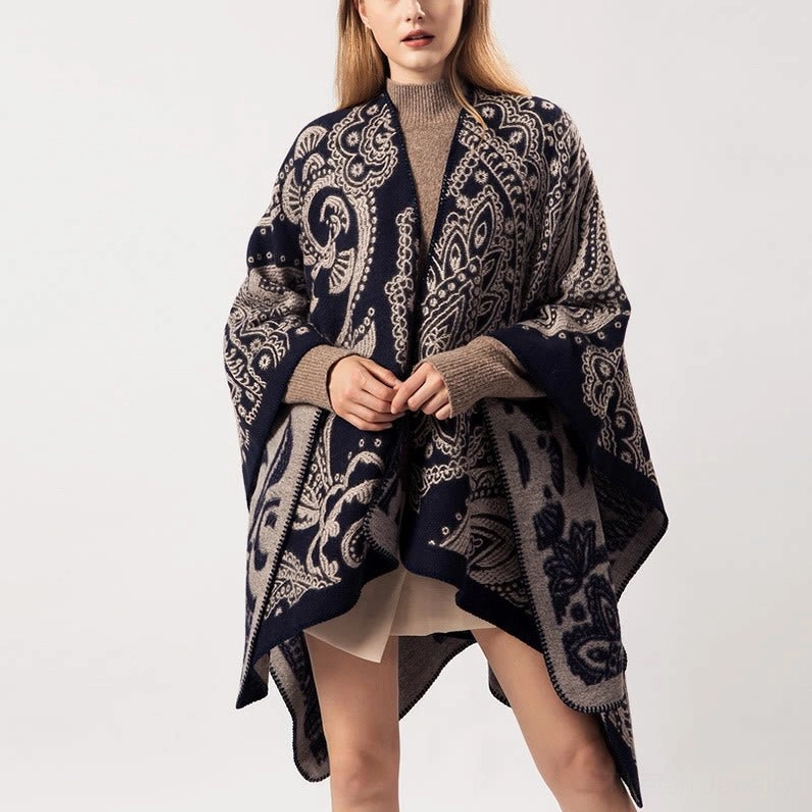 Tibetan poncho shawl close-up front view showing detailed paisley jacquard weave with hands positioned at center
