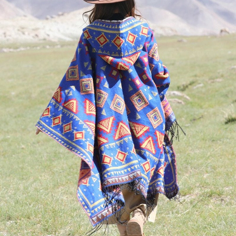 Royal blue Tibetan hooded poncho with red-yellow geometric prints and fringe hem, full back view