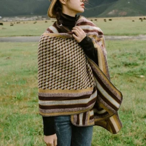 Close-up front view of Tibetan striped houndstooth poncho shawl fabric detail, showcasing tight weave and contrasting hem trim