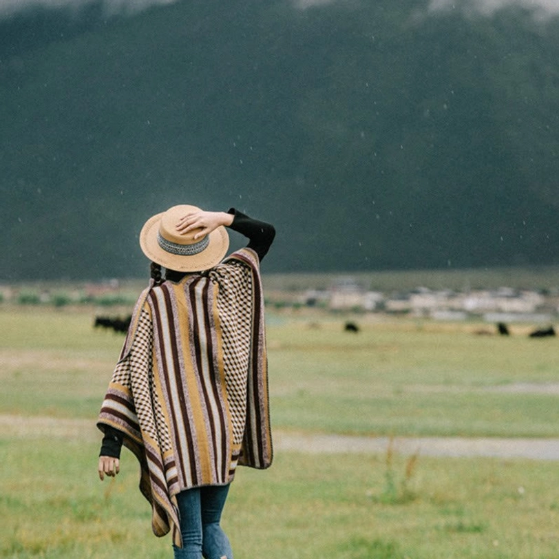 Tibetan striped poncho scarf folded display showcasing compact storage and lightweight design