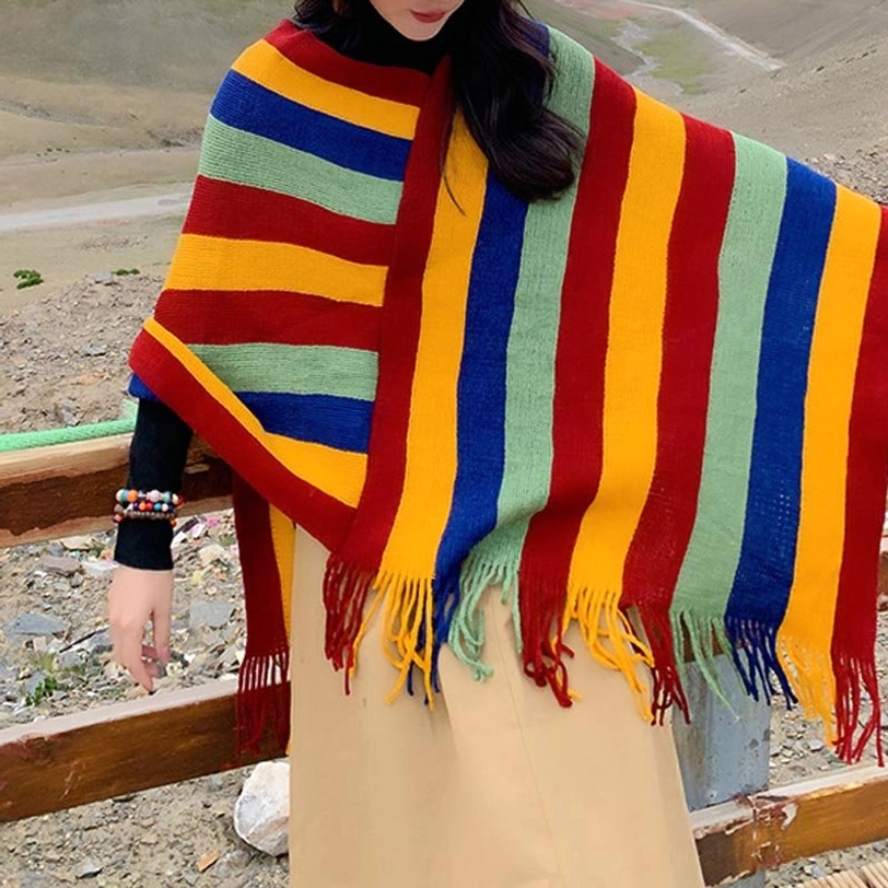 Tibetan poncho shawl right half-body view displaying draped hem tassels and four-color stripe design