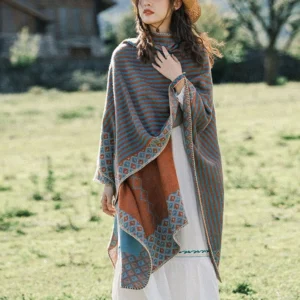 Full front view of Tibetan ethnic striped poncho with oversized draped silhouette and Aztec geometric lower trim in outdoor rural setting