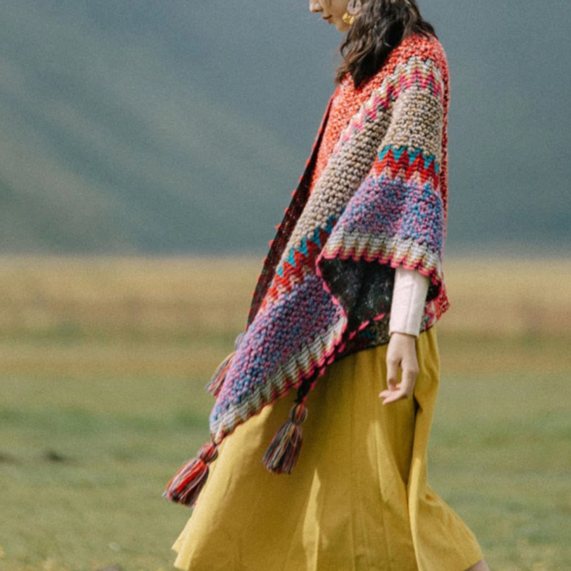 Purple blue red striped ethnic Tibetan knitted poncho with tassel pendants, draped wrap style side view