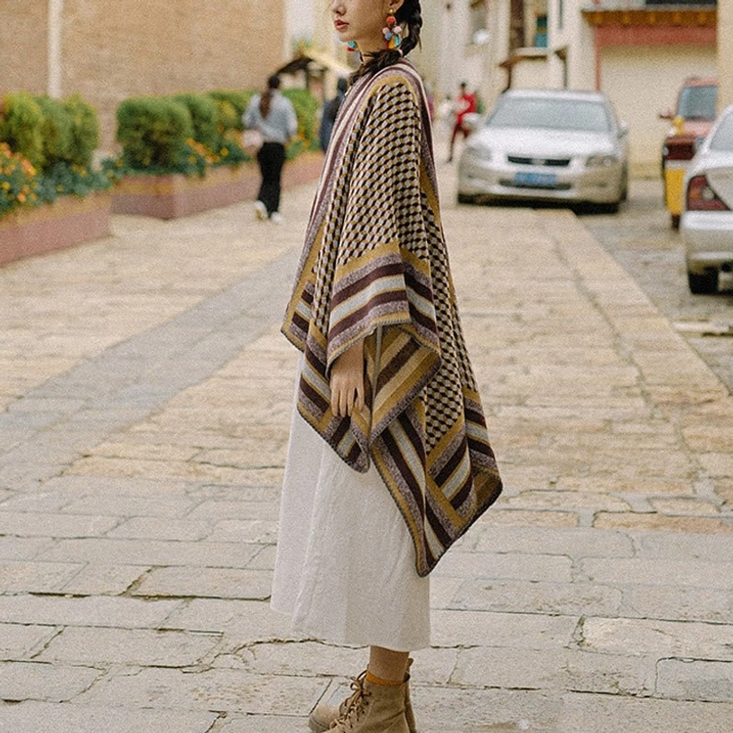Side full-length view of Tibetan houndstooth shawl with draped loose fit worn over casual clothing on residential street