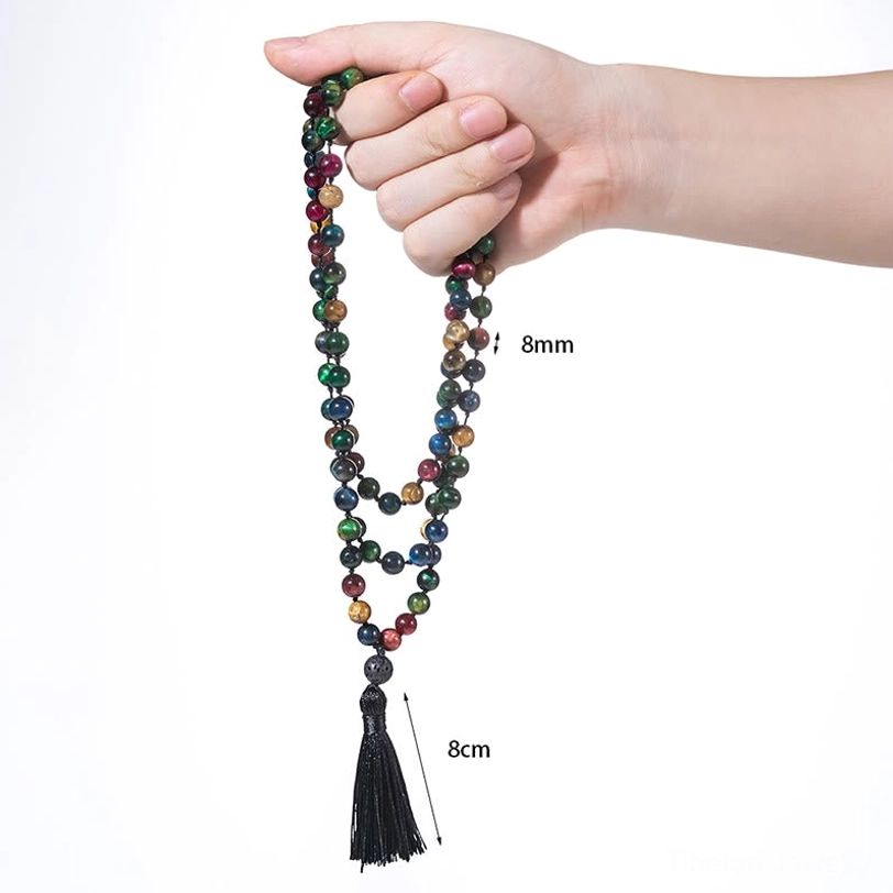 Four-stone tiger eye mala beads displayed in hand showing 8mm mixed color beads 8cm tassel on white background