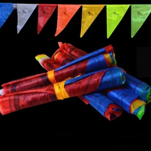 Rolled Tibetan prayer flags bundle with colorful fabric fasteners - studio overhead view