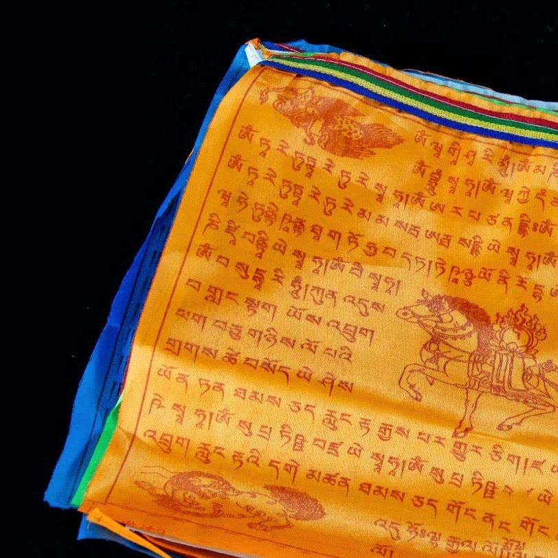 Single orange Tibetan prayer flag with windhorse motif and sacred scriptures printed, multi-color decorative trim edges