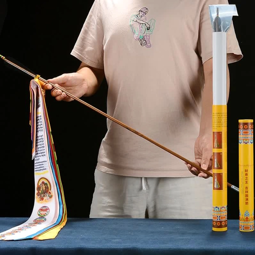 Portable Tibetan prayer flag kit with storage tube held by hand, tabletop display showing complete set ready for transport
