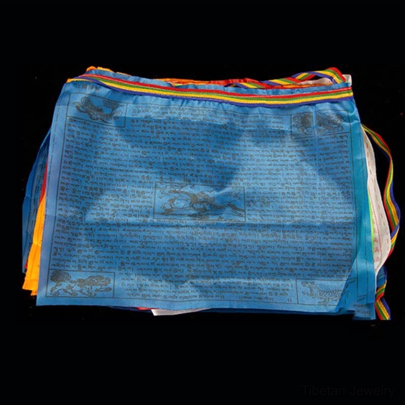 Close-up detail of Tibetan sacred mantras printed on prayer flag fabric with traditional hand-block printing technique