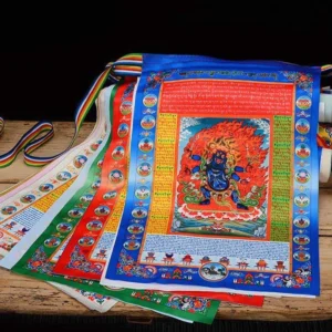 Set of 10 handprinted Tibetan prayer flags with colored hanging straps, arranged on wooden table showing decorative borders and rolled flag bundles