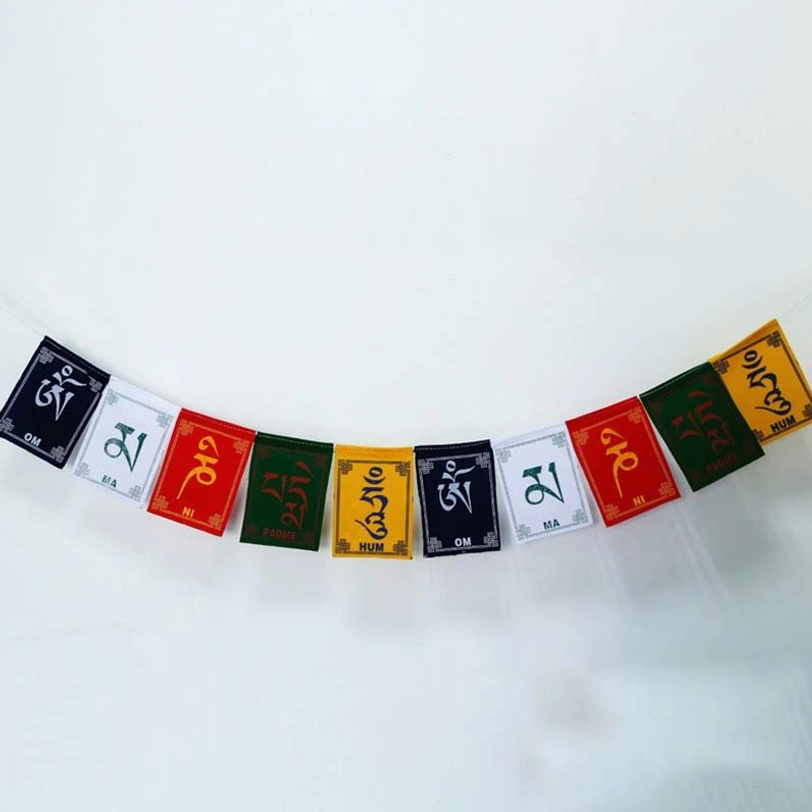 Straight strung multicolored Tibetan prayer flags with mantras displayed on clean white background