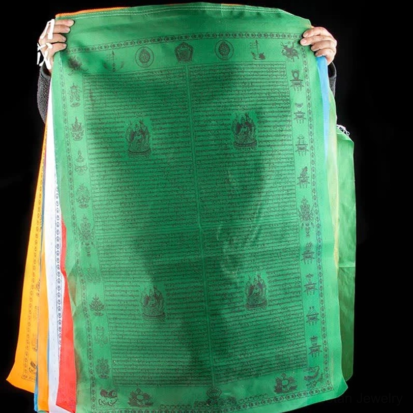 Tibetan prayer flag string hung from wall demonstrating cascading arrangement of 20 flags with sacred Buddhist symbols and mantras