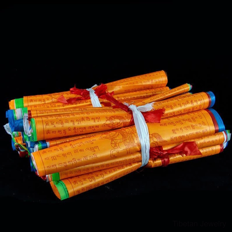 Bundled roll of Tibetan prayer flags tied with fabric straps, showing multiple 5-color traditional flags compact packaging