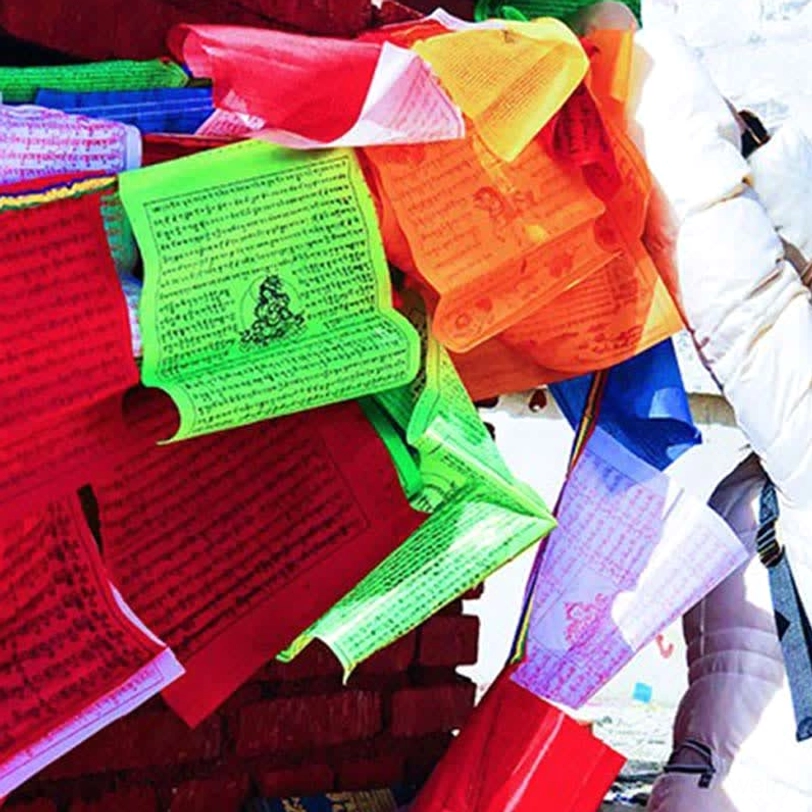 Tibetan prayer flags individual flag detail showing blue white red green yellow color sequence