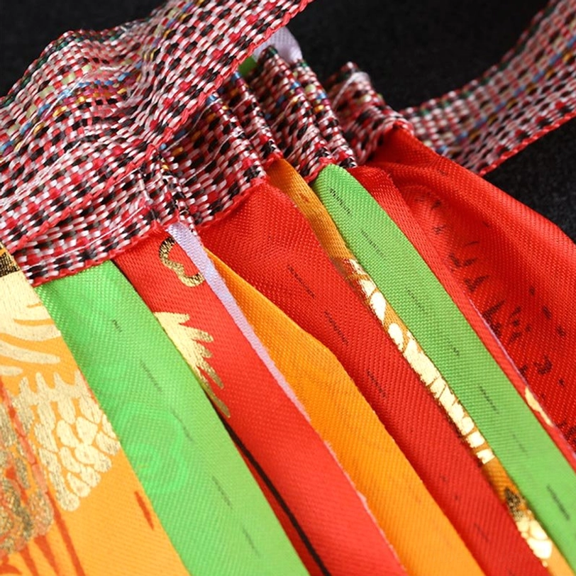 Folded Tibetan prayer flags bundle - grid-patterned hanging loops and vibrant solid color panels