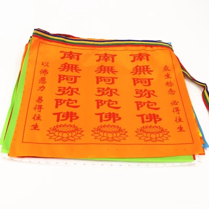 Stacked orange Tibetan prayer flags showing colorful fabric layers and satin texture
