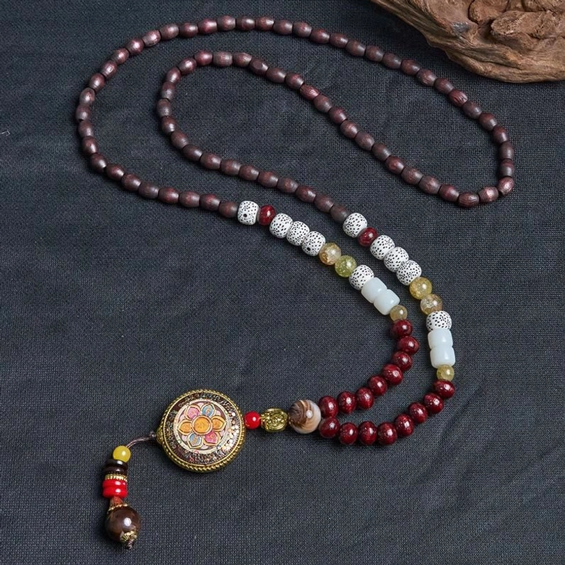 Tibetan Om Mani Padme Hum necklace with stone spacer beads and enamel pendant lay flat