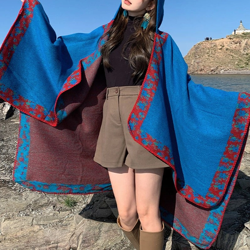 Red Tibetan reversible prayer poncho front view showing vibrant color and authentic floral detailing