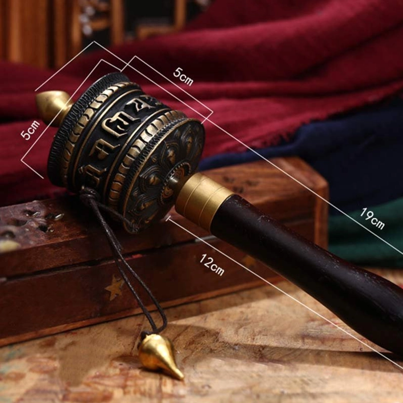 Tibetan copper prayer wheel with dimension labels and size markers showing measurements for reference