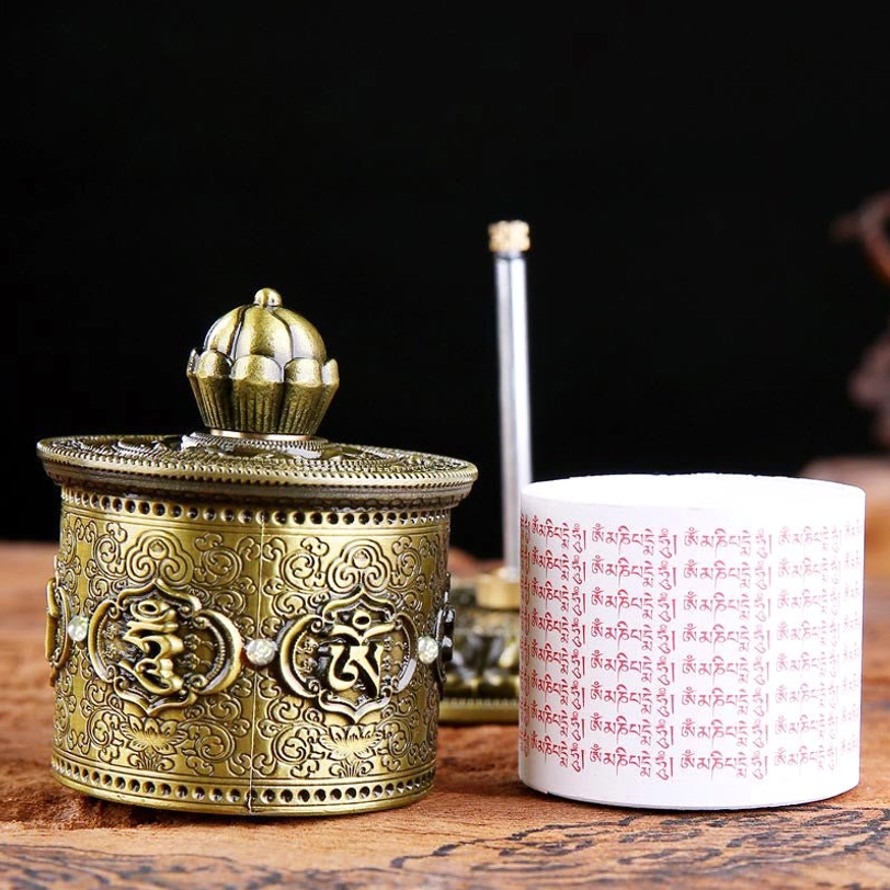 Tibetan prayer wheel disassembled view showing separate barrel with scripture and lotus base components