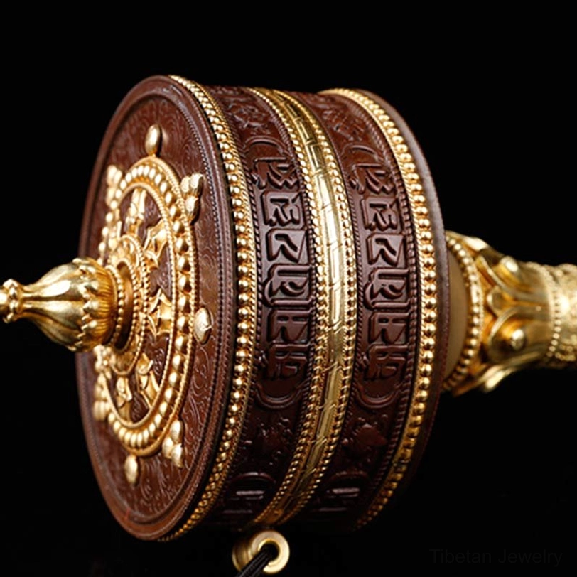 Prayer wheel front end face with gold Dharma wheel and carved base