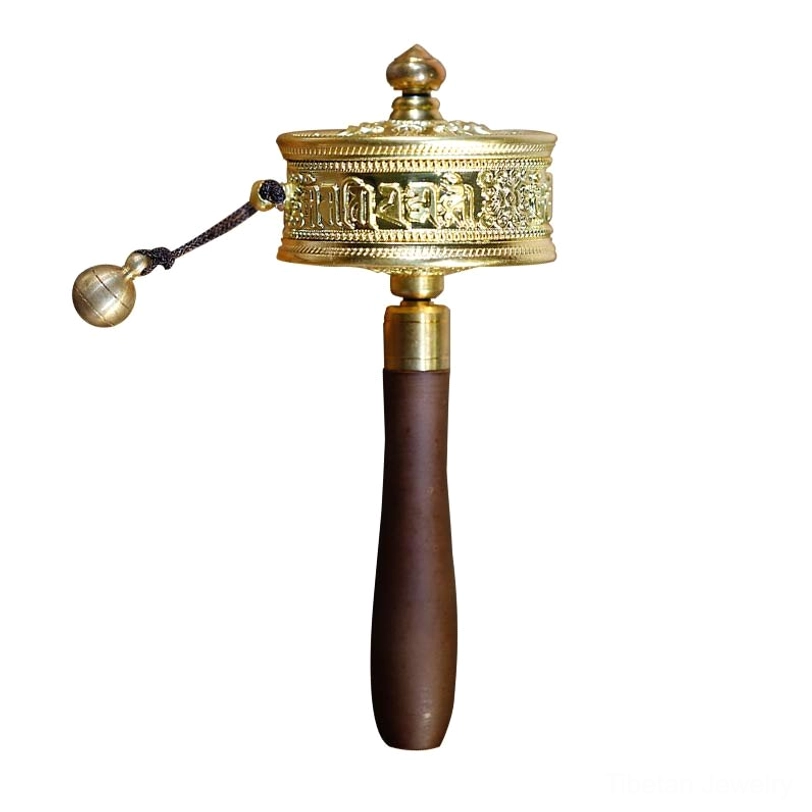 Full front vertical view of handcrafted Tibetan prayer wheel with scripture-carved metal wheel, dark sandalwood wooden handle, and hanging brass bell