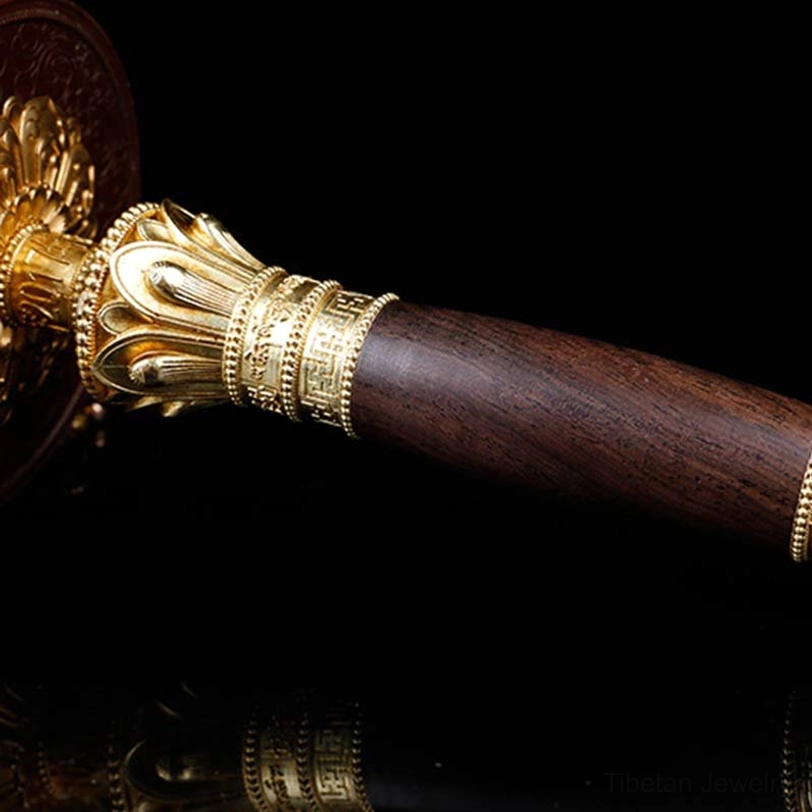 Prayer wheel handle assembly with dark wood and gold metal grip
