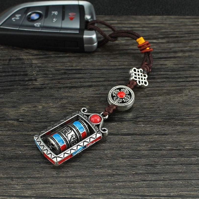 Six true words Tibetan prayer wheel pendant in multiple color variations, silver, turquoise, red, showcasing different style options