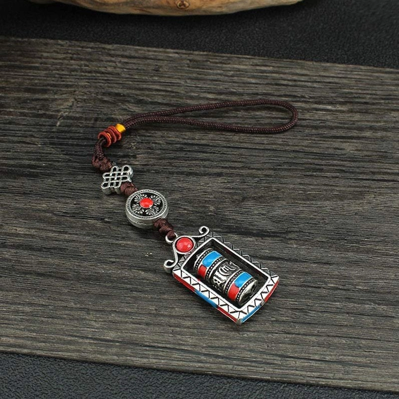 Tibetan prayer wheel keychain packaging or presentation, authentic handmade craftsmanship, Om Mani Padme Hum spiritual accessory