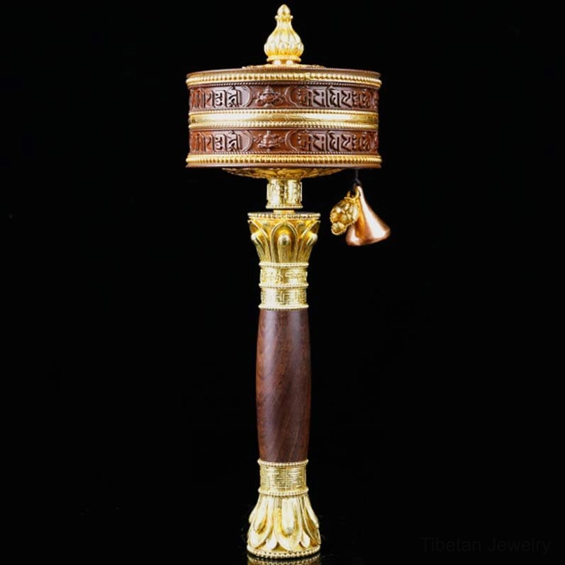 Tibetan prayer wheel side angle view with hanging bell pendant